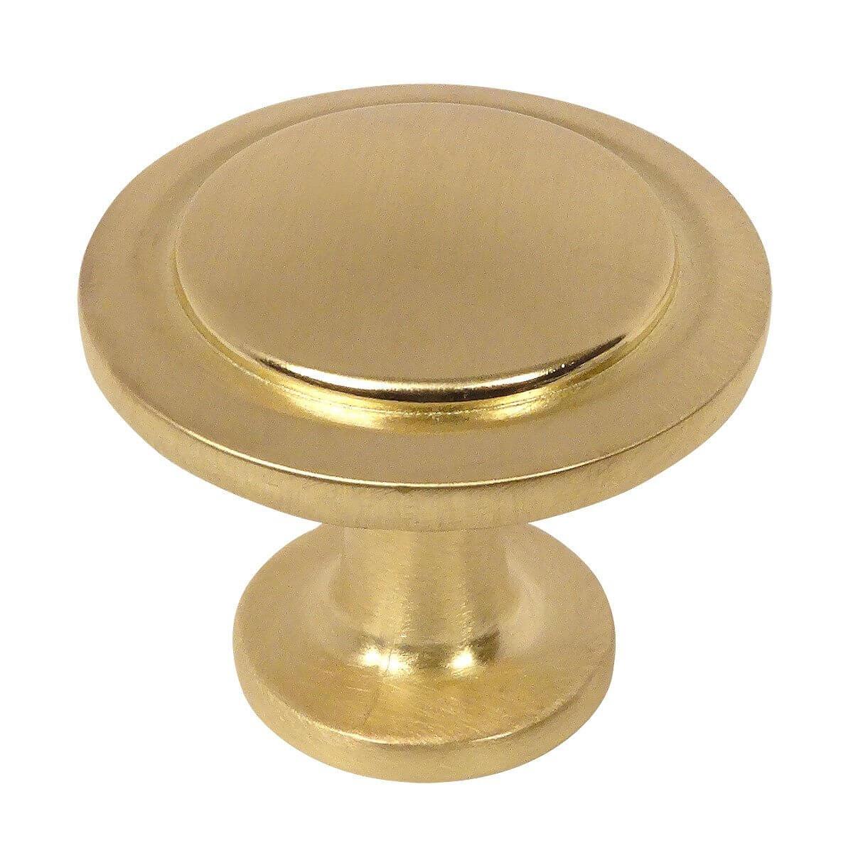Round cabinet knob in brushed brass finish with subtle circle carving